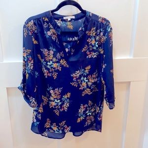 Navy blue tunic top with floral pattern on fabric.